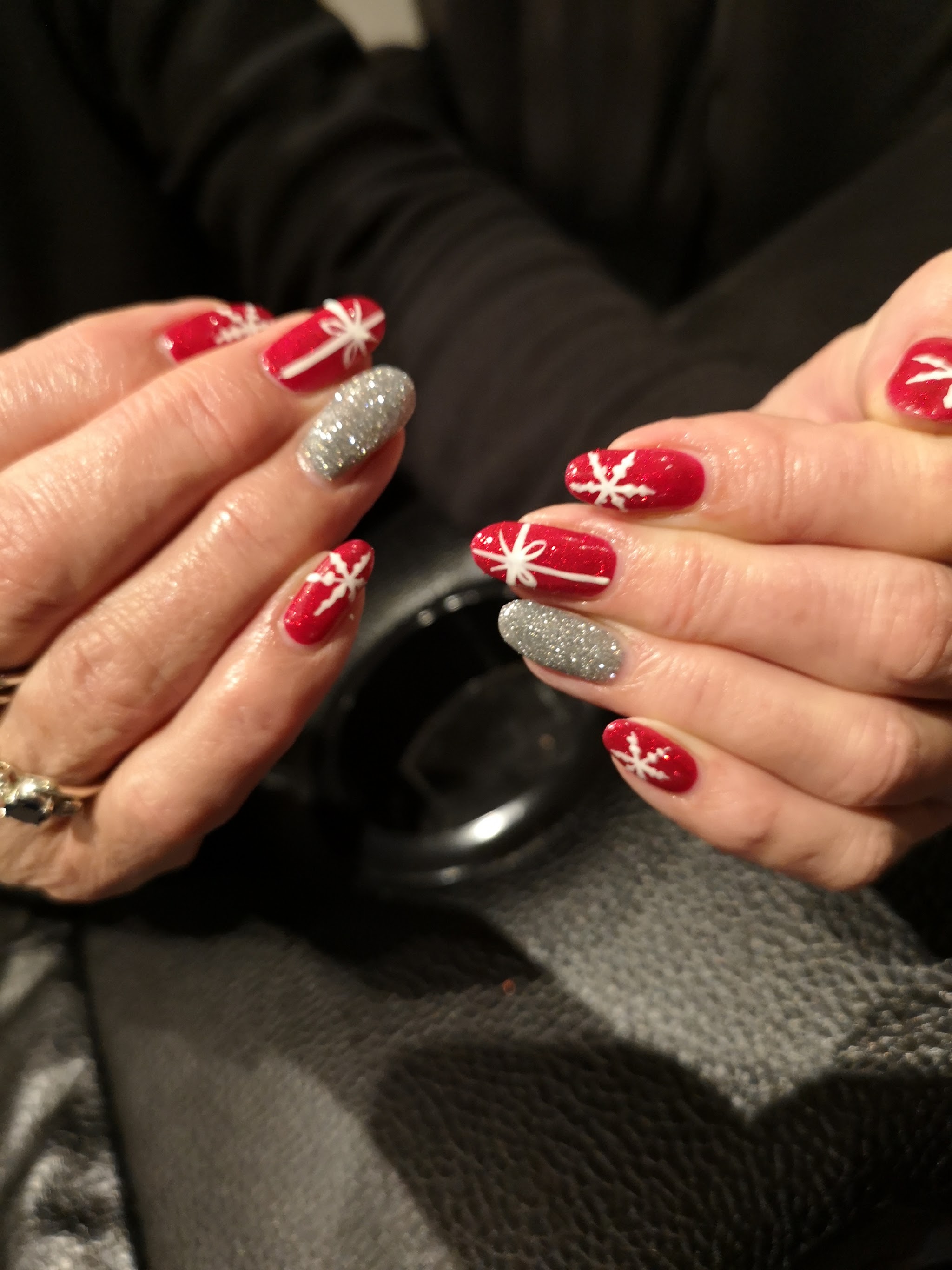 Red Christmas nail art with snowflakes and silver glitter