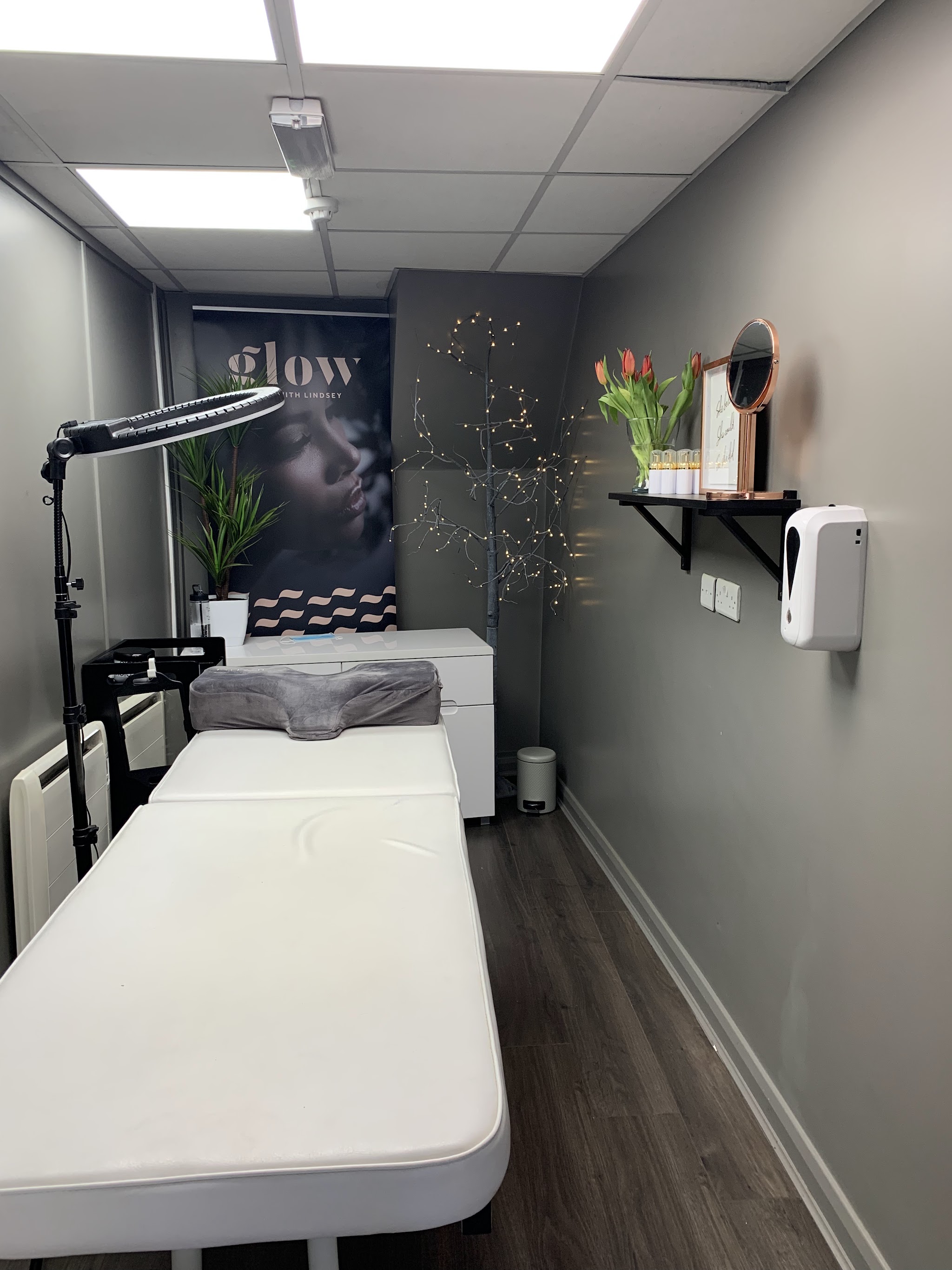 The beauty treatment room with a treatment couch and lamp
